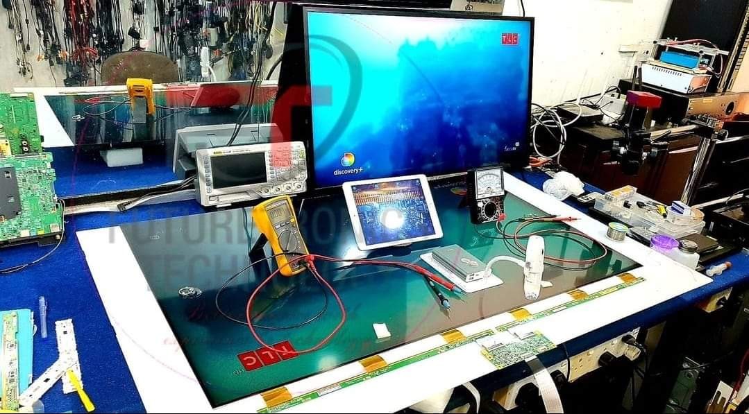 The Art of Drawing Readers In: Your attractive post title goes here TV repair workbench with oscilloscope, multimeter, and open LED TV panel for testing.