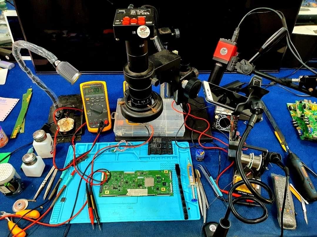 Microscope setup for chip-level LED TV motherboard repair at Thane TV Repair workshop