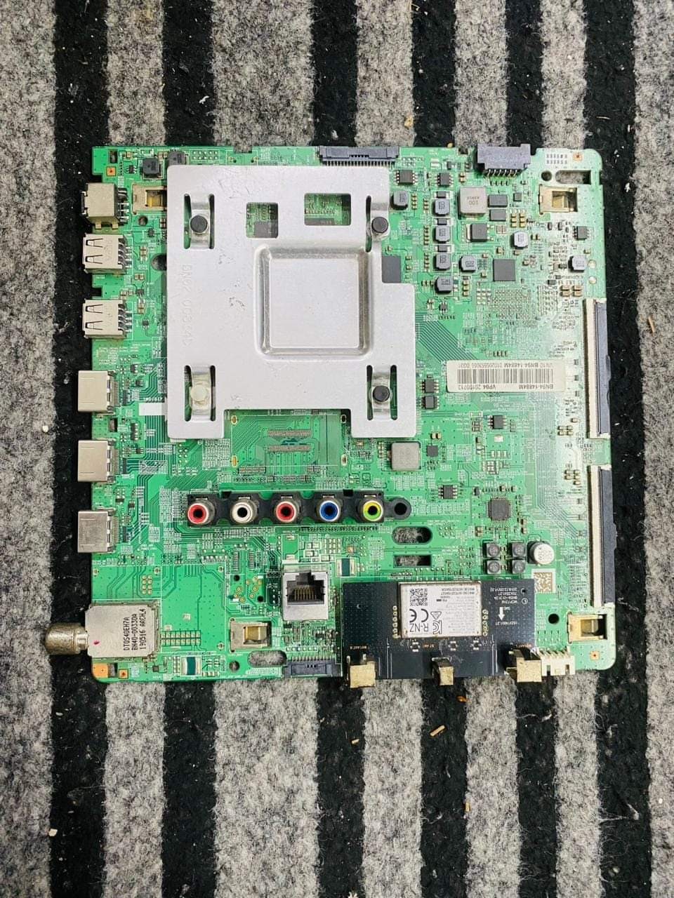 Android Smart TV motherboard with black heatsink and processor.
